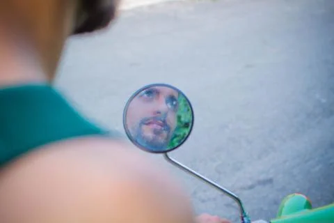 Reflection of a man in a scooter mirror Stock Photos