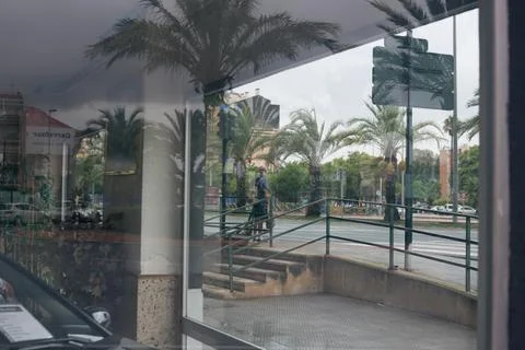 Reflection of a man in a window outside Stock Photos
