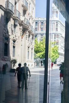 Reflection of a man in a window outside Stock Photos