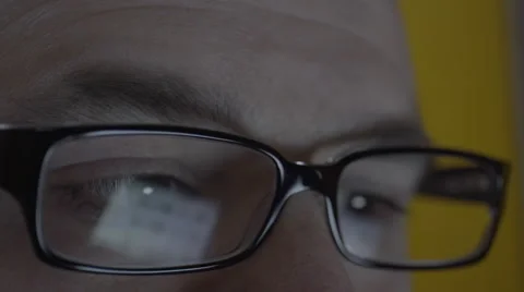 Reflection on mans eyeglasses. 4K UHD Stock Footage 49589523