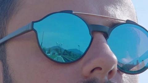 The reflection in the man's sun glasses. Stock Footage 95941520
