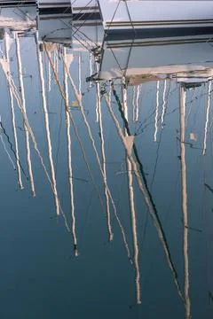 Reflection of masts in the water. Stock Photos
