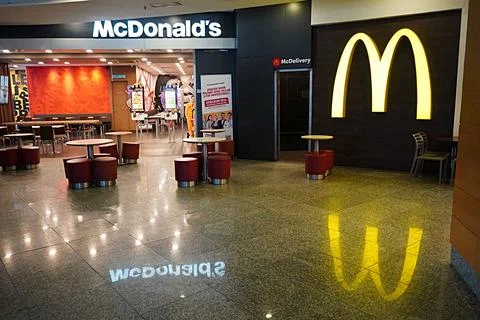 Reflection of McDonald's Logo and name on the floor Stock Photos