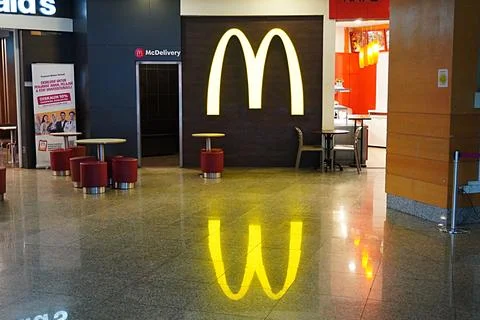 Reflection of McDonald's Logo and name on the floor 스톡 사진