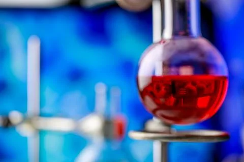 Reflection of microbe from computer screen in red reagent solution inside c.. Stock Photos