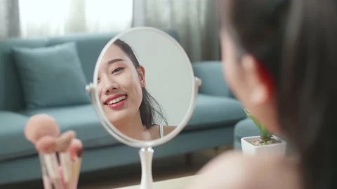 Reflection In A Mirror Beautiful Young Asian Woman Applying Serum And Smiling Stock Footage 218321398
