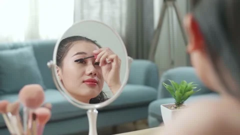 Reflection In A Mirror Beautiful Young Asian Woman Combing Long Black Eyelashes Stock Footage 218321803