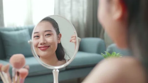 Reflection In A Mirror Beautiful Young Asian Woman Applying Face Cream Stock Footage 218322076