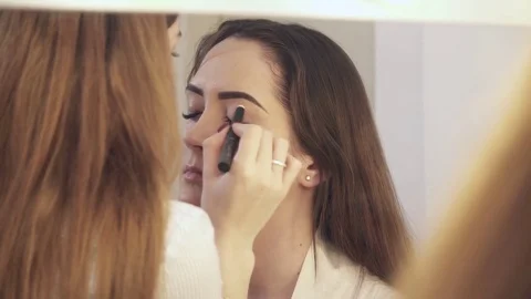 Reflection in the mirror of the makeup creation process Stock Footage 73570632