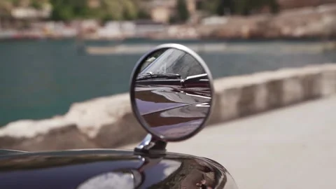 Reflection in the mirror of a retro or classic car standing on the seafront with Stockbeeldmateriaal 137529503