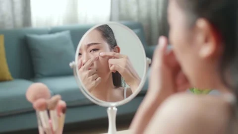 Reflection In A Mirror Worried Young Asian Woman Popping Pimples While Applying Stock Footage 218321308