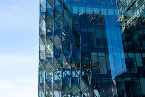Reflection of modern architecture in windows of office building Stock Photos