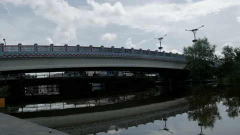 Reflection of modern concrete bridge on the water in the urban village Stock Footage 132530009