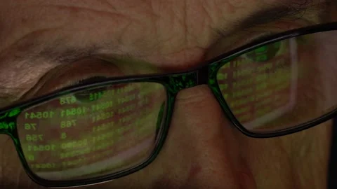 Reflection of the monitor with a numeric code in the programmer's glasses. The Stock Footage 160907107