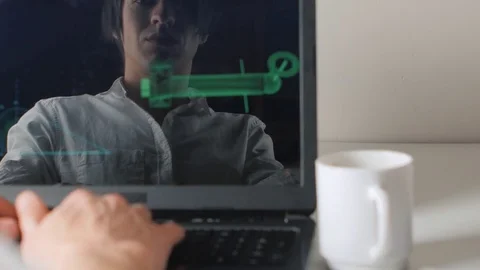 Reflection in the monitor the programmer works at the computer and drinks coffee Stock Footage 74002513