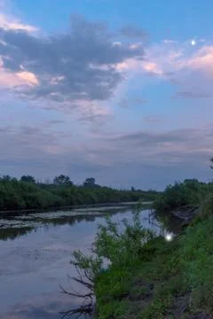 The reflection of the moon and clouds sky sunset at dusk in the water. Stock-Fotos