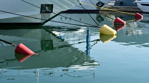 Reflection of moored yachts and multicolored buoys Stock Footage 317381261