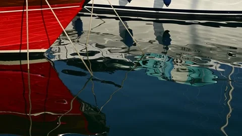 Reflection of moored yachts in the clear blue water of the sea port Video stock 317716054