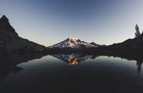 Reflection of Mount Rainier at sunset in water Stock Photos