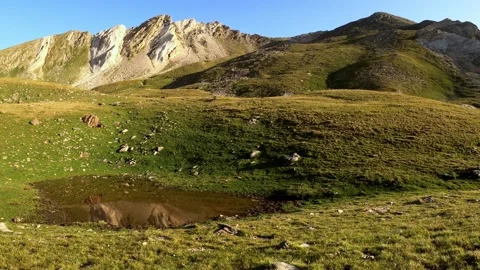 Reflection of the mountain peak in the water - Pyrenees Mountains Stock Footage 142747388