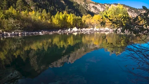 Reflection of mountain peaks in the water of a mountain lake. Stock Footage 158458770
