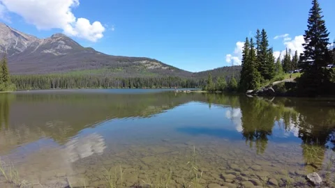 Reflection of mountains and clouds in Pyramid Lake in Jasper National Park Stock Footage 159023722