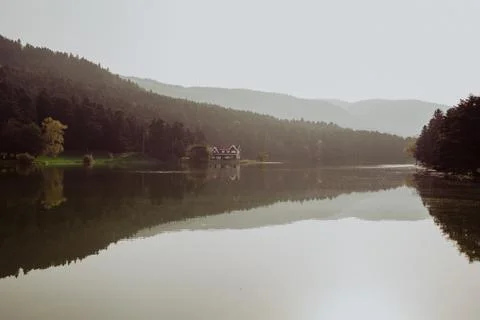 Reflection of mountains and trees on a calm lake like a mirror in autumn Stock Photos