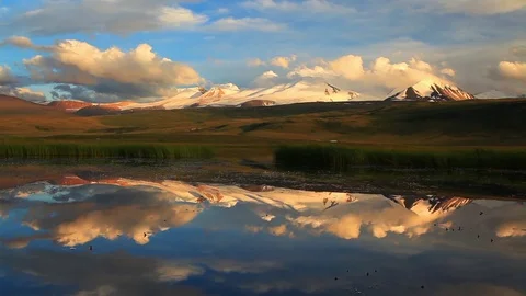 Reflection of mountains in a lake at sunset Stock Footage 72304850