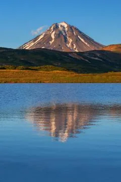 Reflection of mountains in lake at sunset Stock Photos