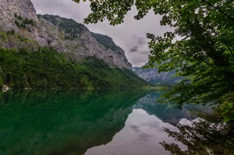 Reflection with mountains by the lake while hiking Stock Photos