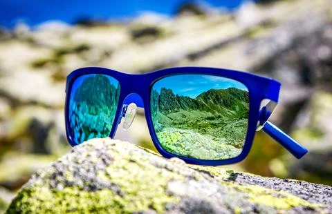 Reflection of mountains in sunglasses Stock Photos