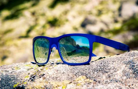 Reflection of mountains in sunglasses Stock Photos