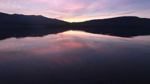 Reflection of mountains at sunset on a lake Stock Footage