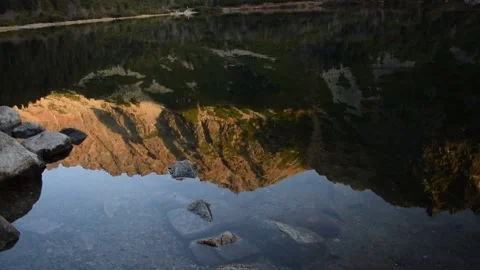 Reflection of mountains on the surface of the mountain lake Stock Footage 132251399