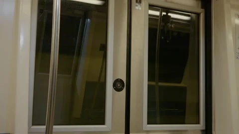 Reflection of movement seen through subway door glass on a travel journey Stock Footage 313618902