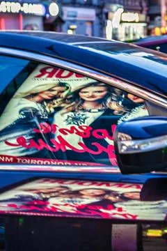Reflection at night of cyrillic advertisement in car window Stock Photos