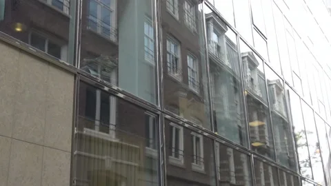 Reflection of an old building in a glass building Video stock 94625197