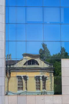Reflection old building in glass wall Stock Photos