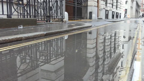 Reflection of an old building in a street puddle. Stock Footage 115956000