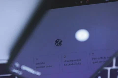 Reflection of OpenAI ChatGPT chatbot app on smartphone screen Foto stock