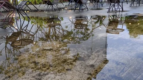 Reflection of Outdoor Chairs on Wet Surface After Rainfall Vídeos de archivo 304617406