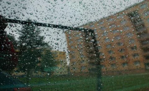 Reflection of the panel house on a window with rain drops. Stock Photos