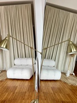 Reflection of a part of the interior with a lamp and an upholstered chair in the Stock Photos