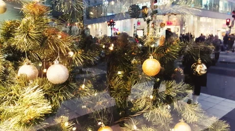 Reflection of people over Christmas tree on showcase of shop during new year Stock Footage 58953342