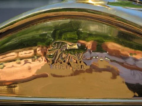 Reflection of People on a Shiny Golden Surface Highlighting Craftsmanship i.. Stock Photos