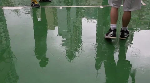 Reflection of playing basketball in the wet surface after rain playground, Hong Stock Footage 50669689