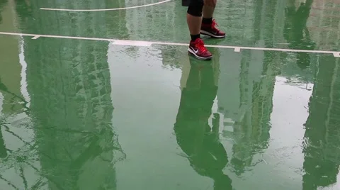 Reflection of playing basketball in the wet surface after rain playground, Hong Stock Footage 50669764