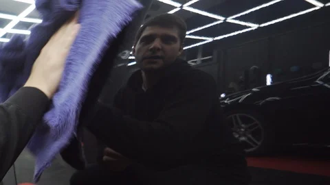 In reflection of polished car body, workshop is visible, excellent polisher work Stock Footage 115931498