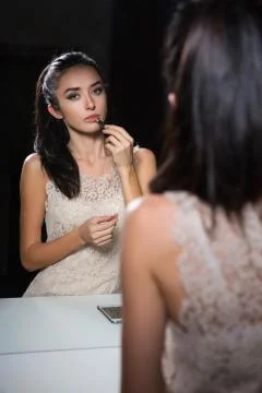 Reflection of pretty young brunette Stock Photos