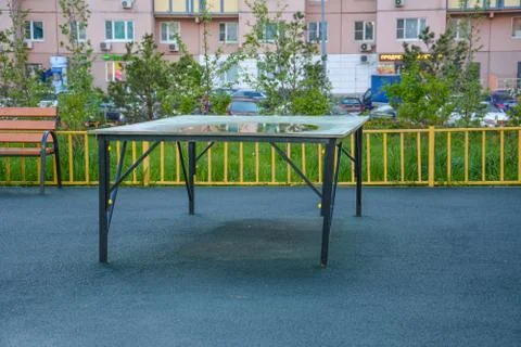 Reflection in the puddle. Tennis table on the playground. Copy space Stock Photos